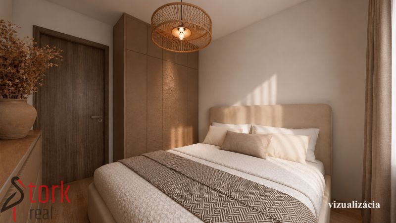 Schlafzimmer in einer 2-Zimmer-Wohnung mit Bett, Kleiderschrank und Boden in Holzoptik.