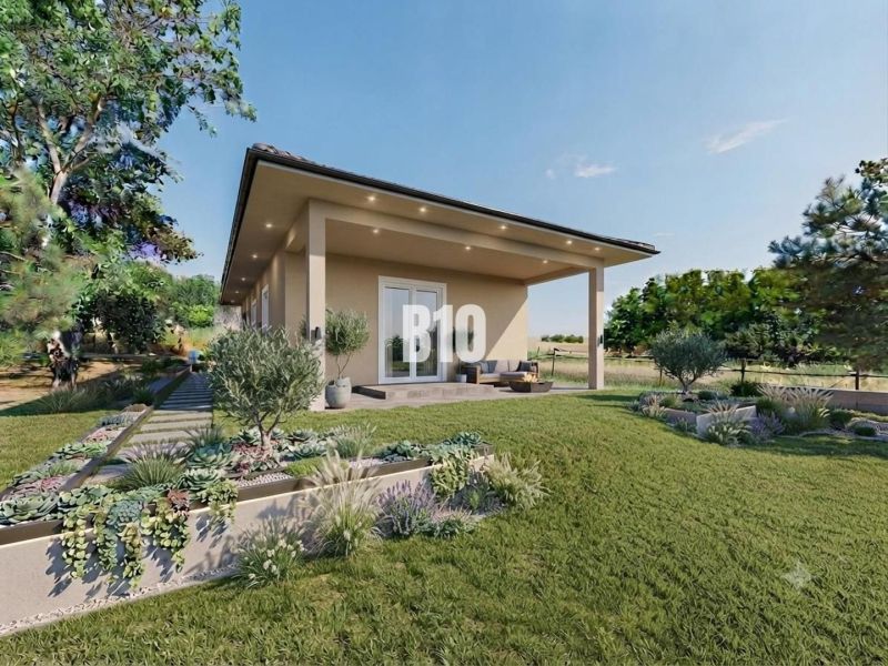 Ein Einfamilienhaus in Čeľadice, umgeben von einem Garten mit Terrasse und Grünflächen.