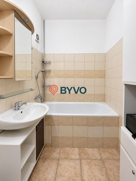 Badezimmer mit Badewanne, Waschbecken und Keramikfliesen in einer 4-Zimmer-Wohnung.
