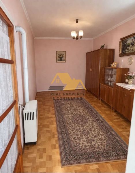 Innenraum eines Einfamilienhauses mit Holzdekorboden, Teppich und Schränken.