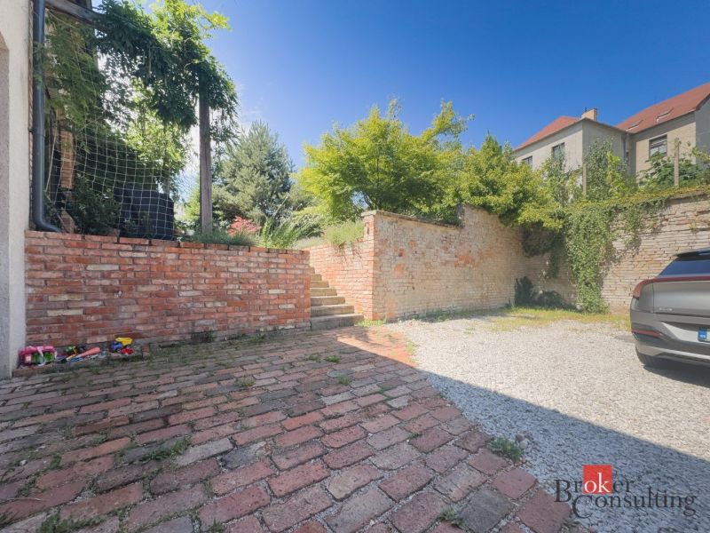 Außenbereich einer 3-Zimmer-Wohnung in der Čajakova-Straße in Bratislava-Neustadt mit einer Ziegelmauer.