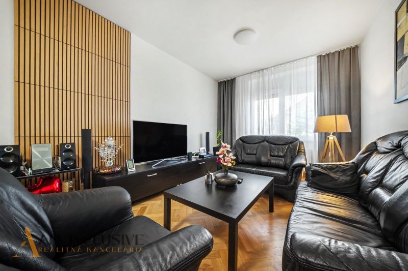 Wohnzimmer eines Einfamilienhauses mit Ledersofas und Holzboden.