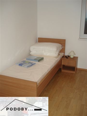 Einzelbett mit Holzboden in einer 3-Zimmer-Wohnung.