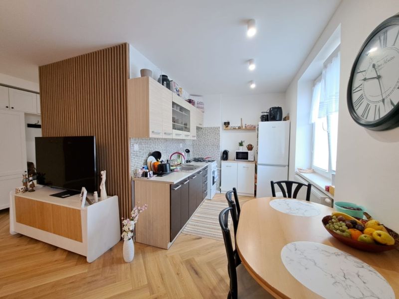 Küche und Esszimmer in einer 3-Zimmer-Wohnung mit Holzboden.