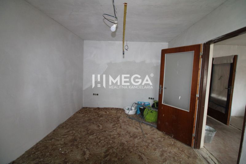 Ein Zimmer in einem Einfamilienhaus mit einem Boden in Holzoptik und Malutensilien.