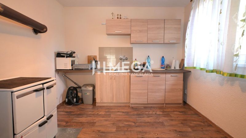 Eine Küche in einem Einfamilienhaus mit Holzboden-Dekor und hellen Möbeln.