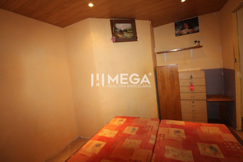 Schlafzimmer mit Bett, Kommode und Boden mit Holzdekor in einer 3-Zimmer-Wohnung.