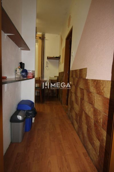 Ein Flur mit einem Boden in Holzoptik führt in den Essbereich einer 3-Zimmer-Wohnung.