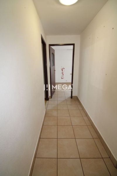 Flur mit hellen Wänden und Fliesen in einer 3-Zimmer-Wohnung.