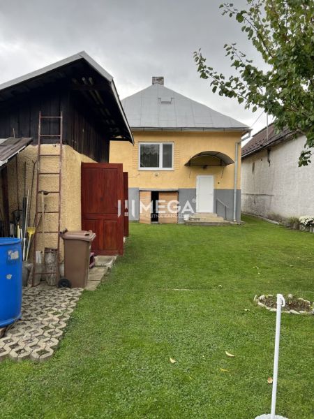 Ein Einfamilienhaus in der Jesenského-Straße in Snina, mit grünem Rasen und Zubehör.