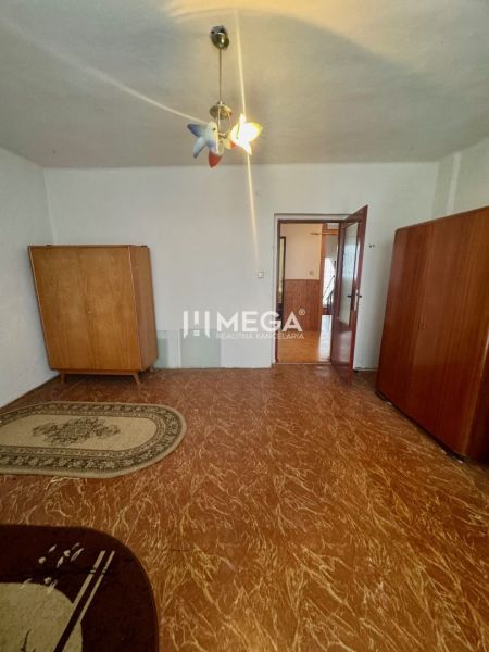 Ein Zimmer in einem Einfamilienhaus mit Schränken, Licht und einem Boden in Holzoptik.