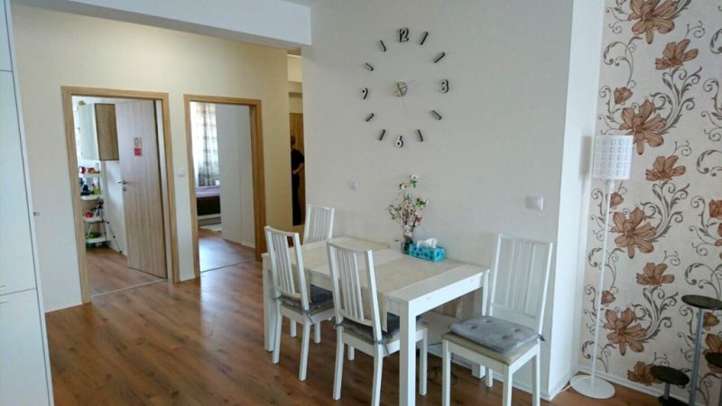 Esszimmer in einer 3-Zimmer-Wohnung mit Holzboden und Blumenmuster-Tapete.