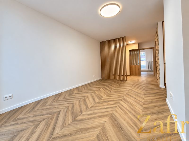 Innenraum einer 3-Zimmer-Wohnung mit Holzboden und Holztrennwänden.