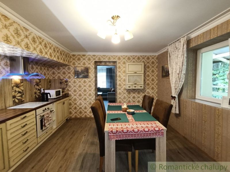 Innenraum eines Einfamilienhauses mit Holzboden, Esstisch und Tapeten.
