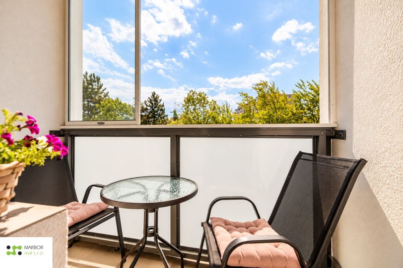 Ein Balkon mit runden Tisch und zwei Stühlen in einer 3-Zimmer-Wohnung.