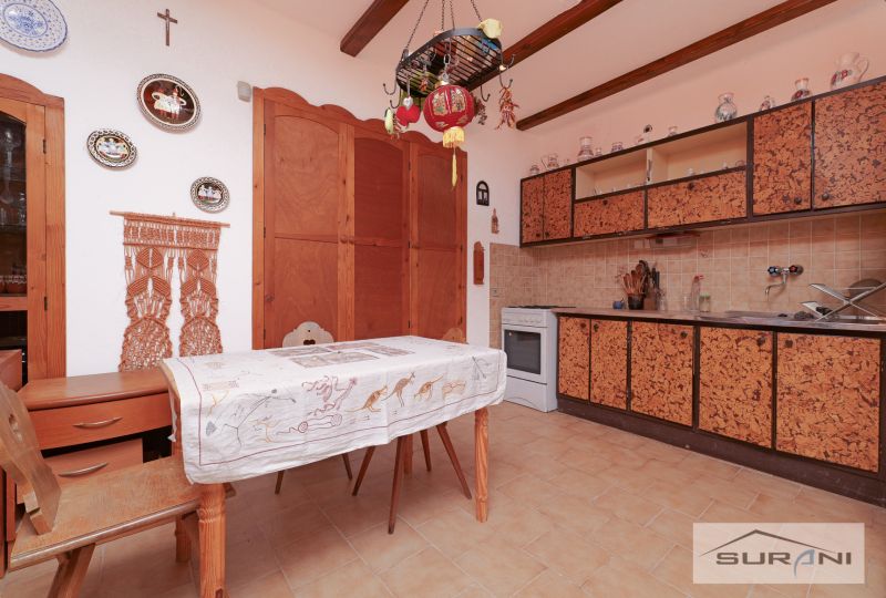 Eine Küche in einem Einfamilienhaus mit rustikalem Dekor und Wanddekorationen über dem Tisch.