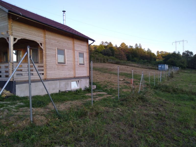 Eine Holzhütte in Horná Breznica am Waldrand mit neuem Zaun.