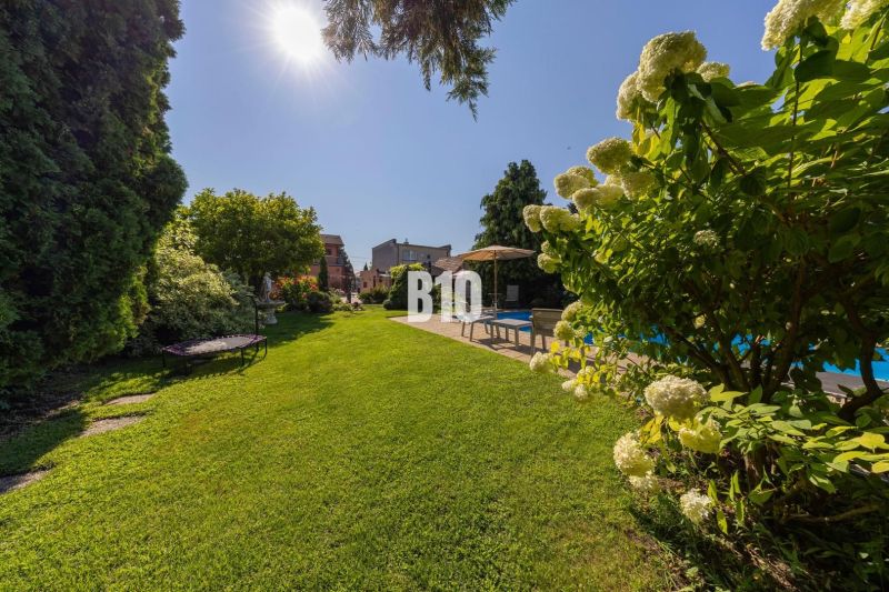 Der Garten eines Einfamilienhauses in der Bratislavská-Straße in Malinovo mit Pool und Grünflächen.